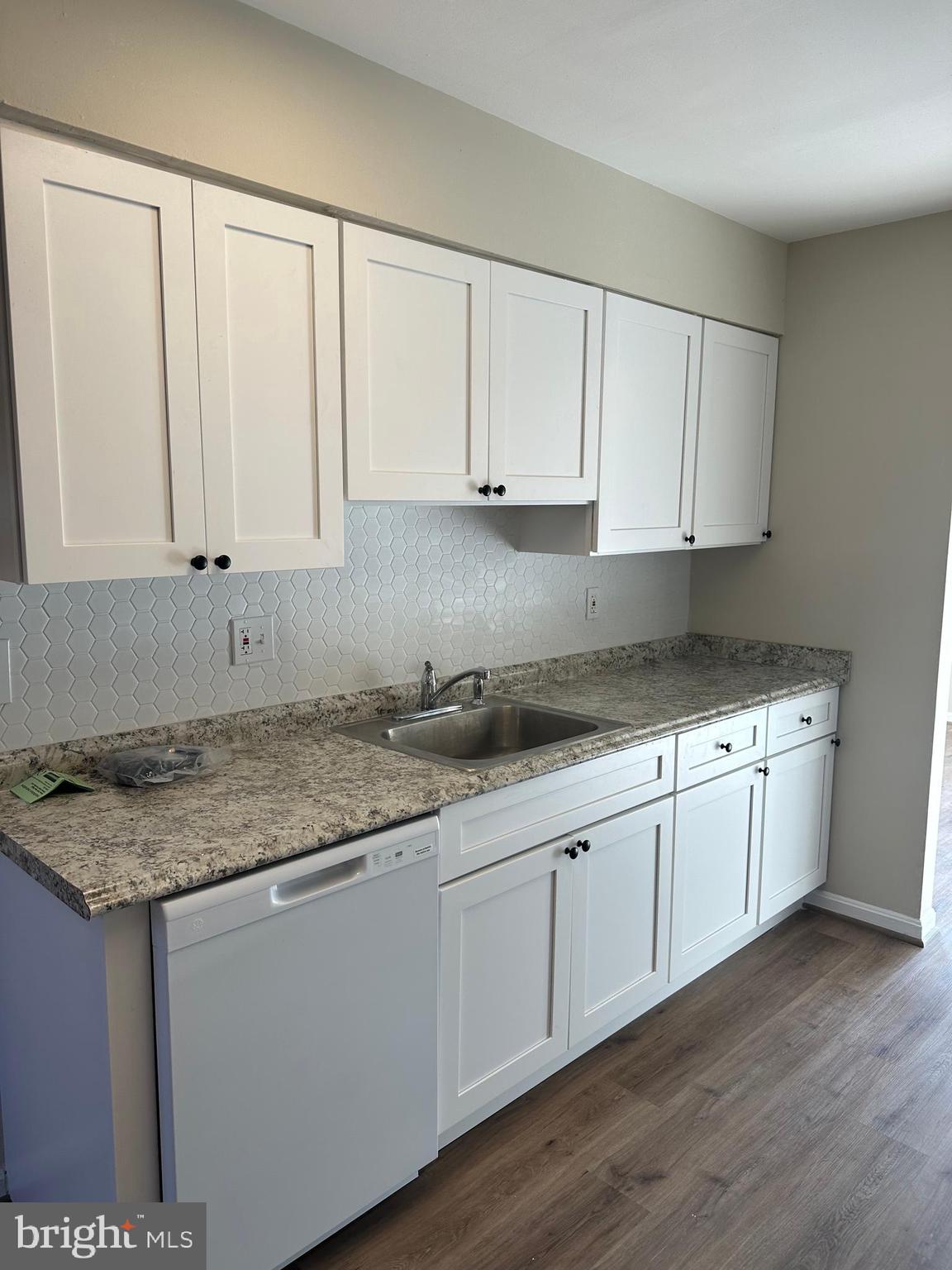 9637 Axehead Court Randallstown, MD 21133 - Photo 4 of 10 a kitchen with granite countertop white cabinets and sink