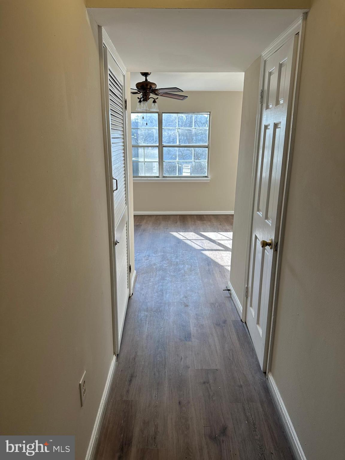 9637 Axehead Court Randallstown, MD 21133 - Photo 6 of 10 wooden floor in an empty room with a window