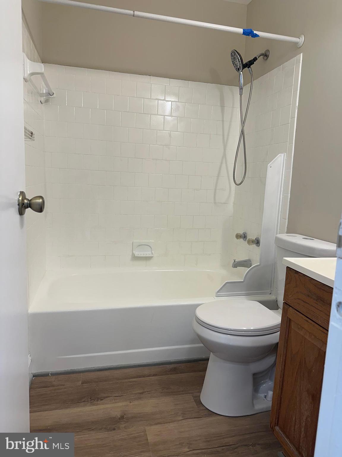9637 Axehead Court Randallstown, MD 21133 - Photo 7 of 10 a bathroom with a sink a toilet and shower