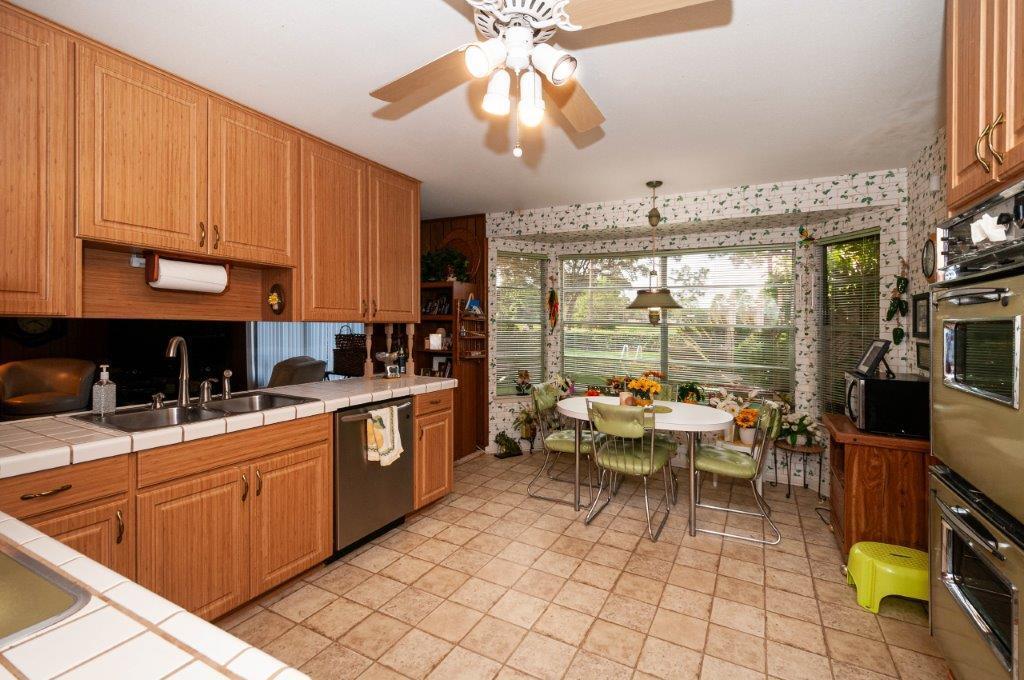 90 Country Club Road Shalimar, FL 32579 - Photo 11 of 41 a kitchen with a sink and cabinets