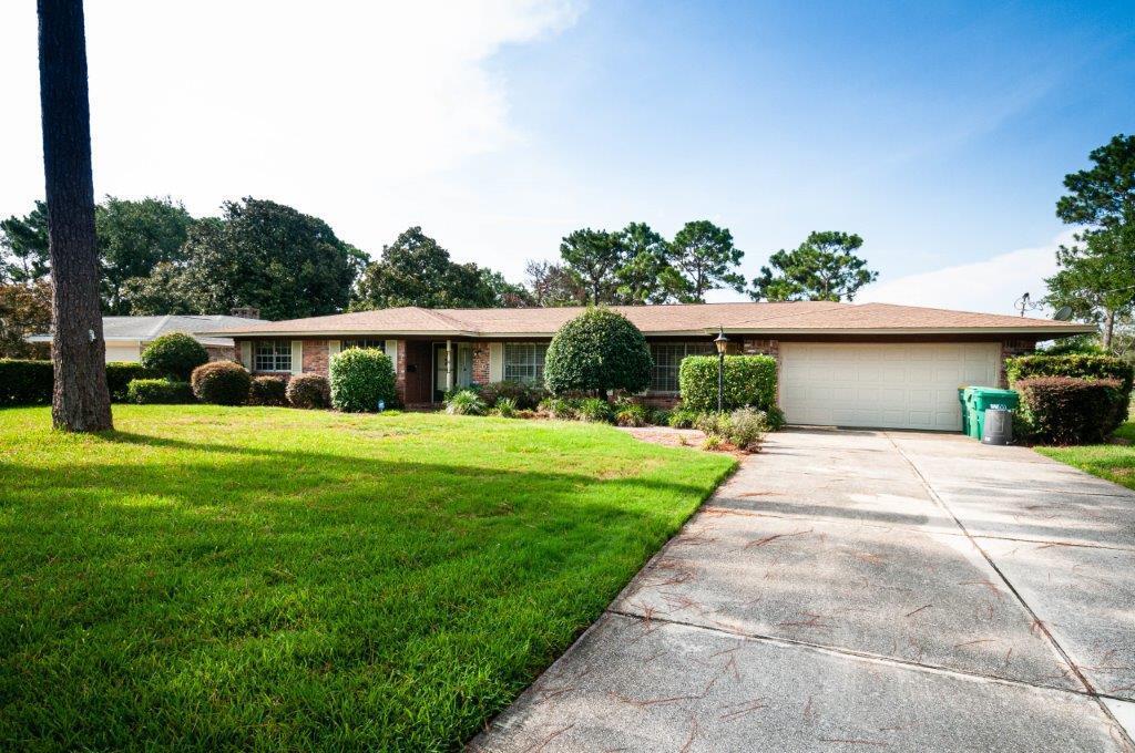 90 Country Club Road Shalimar, FL 32579 - Photo 2 of 41 a front view of house with a garden