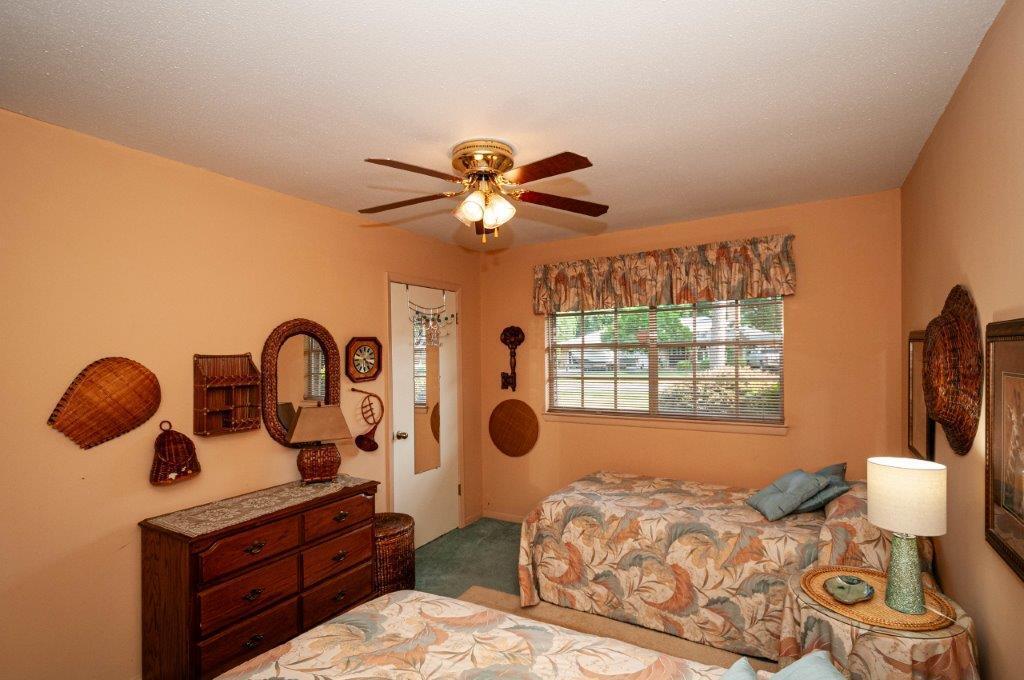 90 Country Club Road Shalimar, FL 32579 - Photo 22 of 41 a bedroom with furniture and a large window