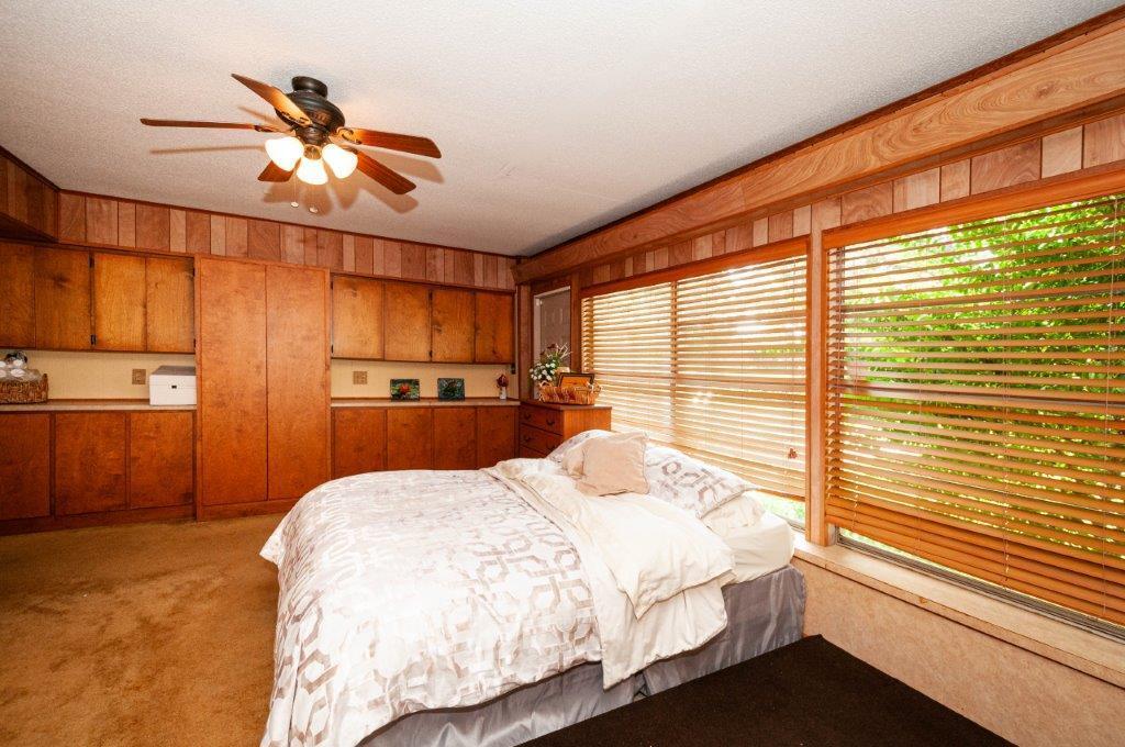 90 Country Club Road Shalimar, FL 32579 - Photo 32 of 41 a bedroom with a large bed and a chandelier