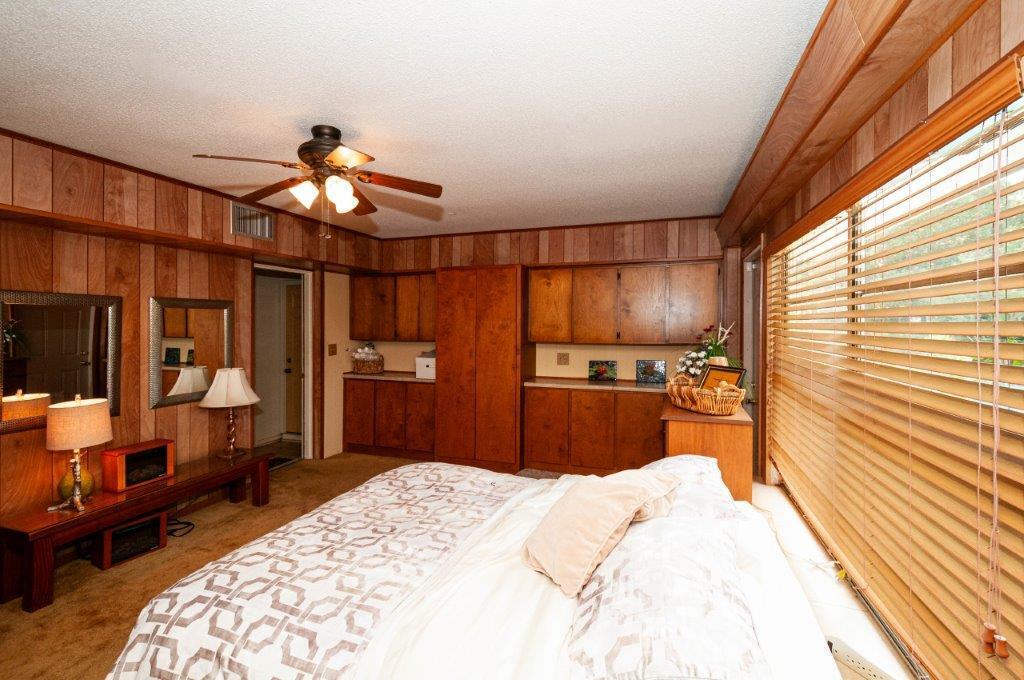 90 Country Club Road Shalimar, FL 32579 - Photo 33 of 41 a bedroom with a bed and wooden floor
