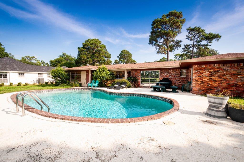 90 Country Club Road Shalimar, FL 32579 - Photo 6 of 41 a view of a swimming pool with a patio
