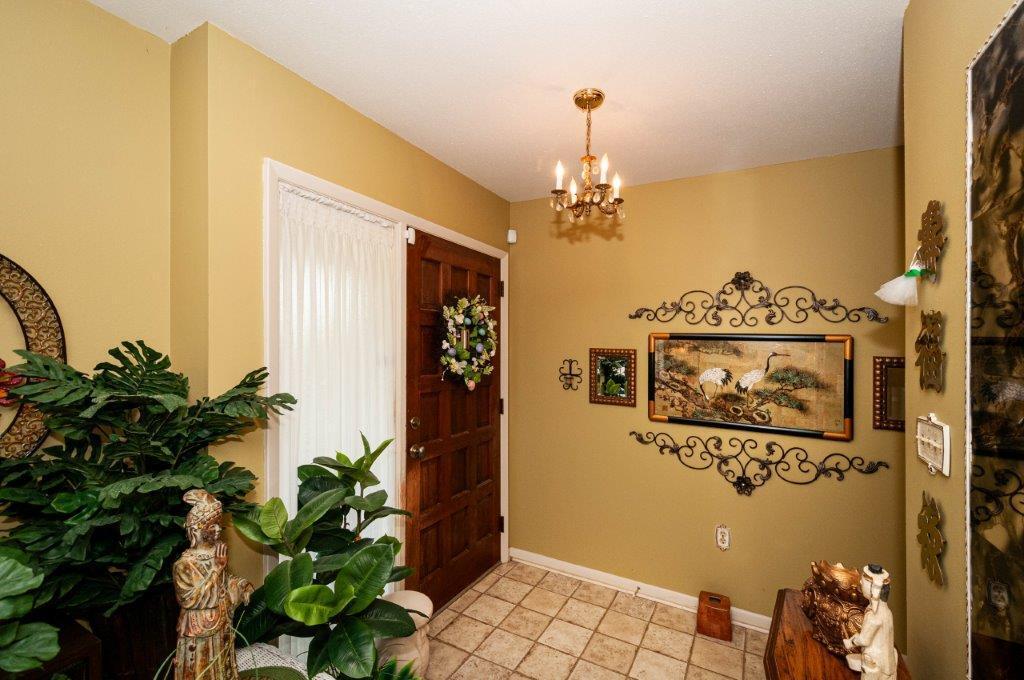 90 Country Club Road Shalimar, FL 32579 - Photo 8 of 41 a view of a hallway with paintings on the wall