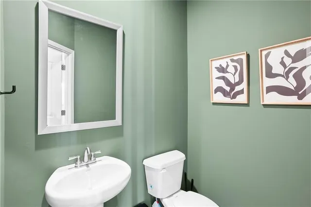 a bathroom with a granite countertop sink toilet and a tub