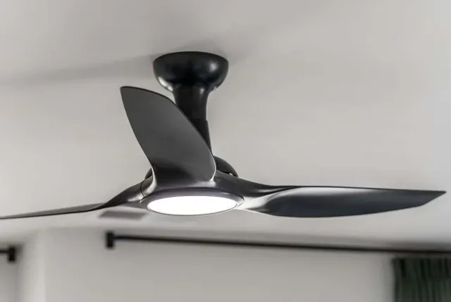 a room with a bed and a lamp on dresser