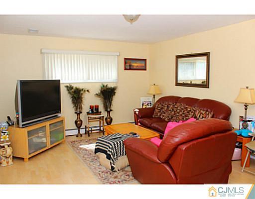 166 Winthrop Road Edison, NJ 08817 - Photo 3 of 17 a living room with furniture and a flat screen tv