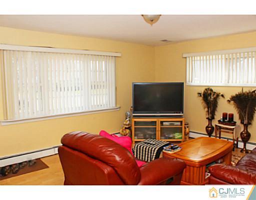 166 Winthrop Road Edison, NJ 08817 - Photo 4 of 17 a living room with furniture and a flat screen tv