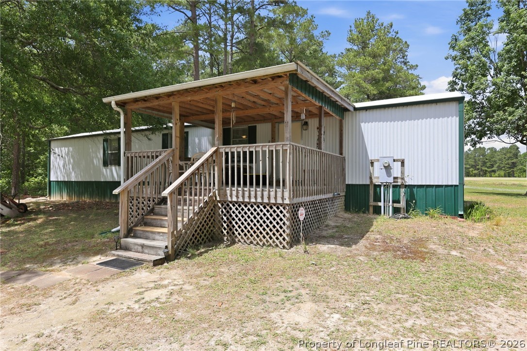 10400 Ruth Vinson Road Autryville, NC 28318 - Photo 38 of 49 a view of a house with a small yard and wooden fence