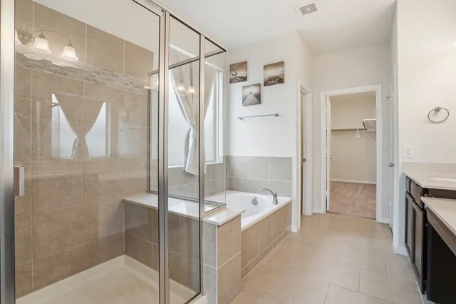 a bathroom with a bathtub and a shower