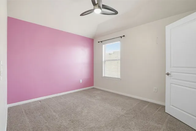 a view of a livingroom with a ceiling fan and window