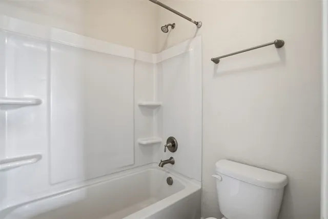a bathroom with a bathtub and a toilet