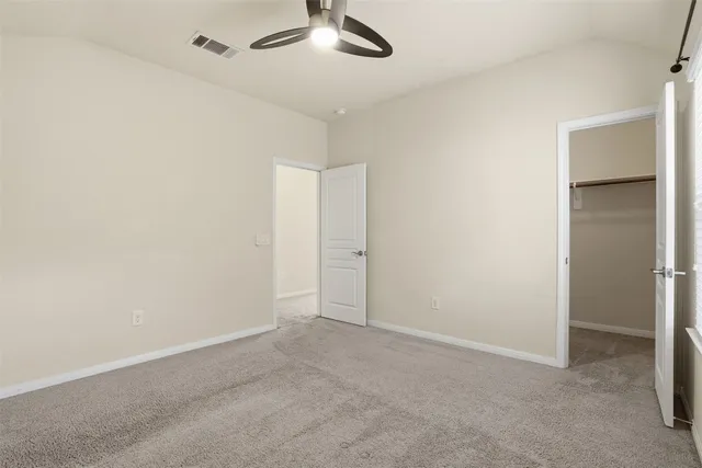 an empty room with a empty space and a ceiling fan