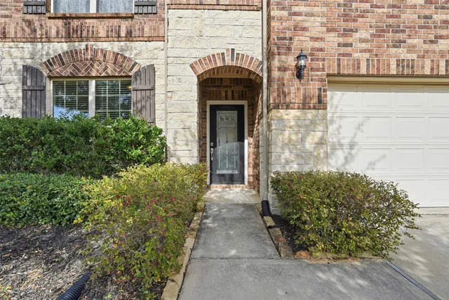 front view of a brick house with a large windows