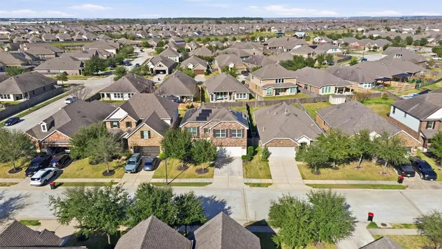 an aerial view of residential houses with outdoor space