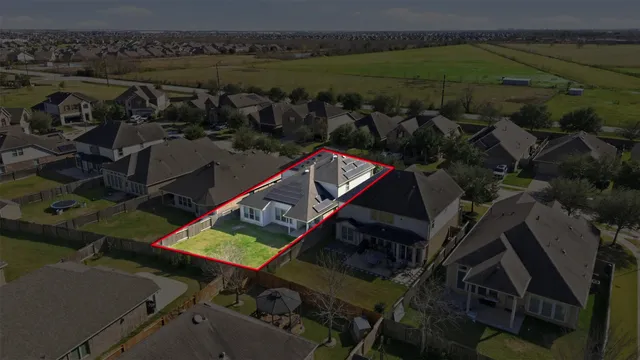 an aerial view of a house with a lake