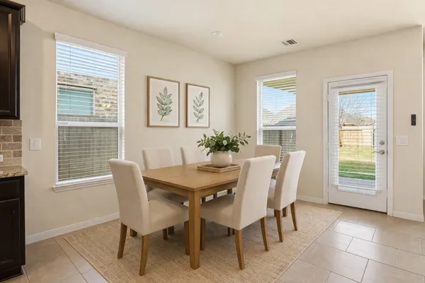 a view of a dining room with furniture and a large window