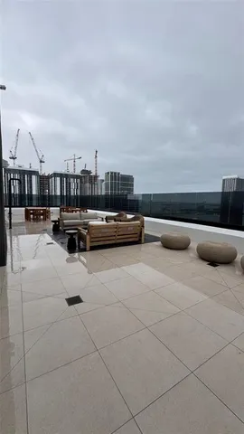 a terrace with outdoor seating and city view