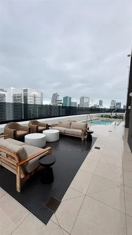a view of swimming pool with outdoor seating and city view
