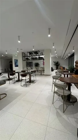 a living room with lots of furniture and view kitchen