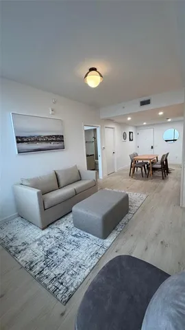 a living room with furniture and a lamp