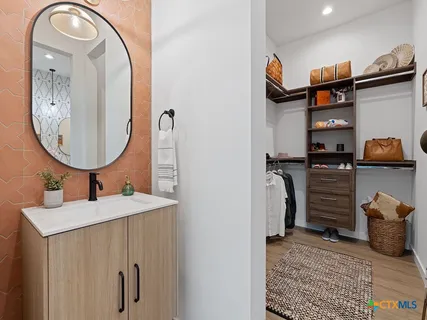 a bathroom with a sink a mirror and shower