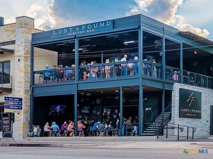 a view of a chairs and a table and tables in the patio