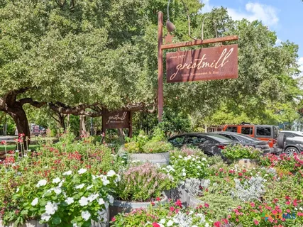 a sign that is in front of flowers