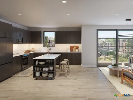 a kitchen with a dining table chairs and refrigerator