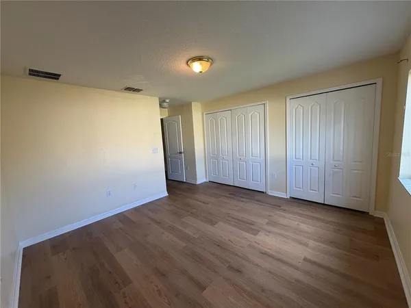 a view of hallway with wooden floor