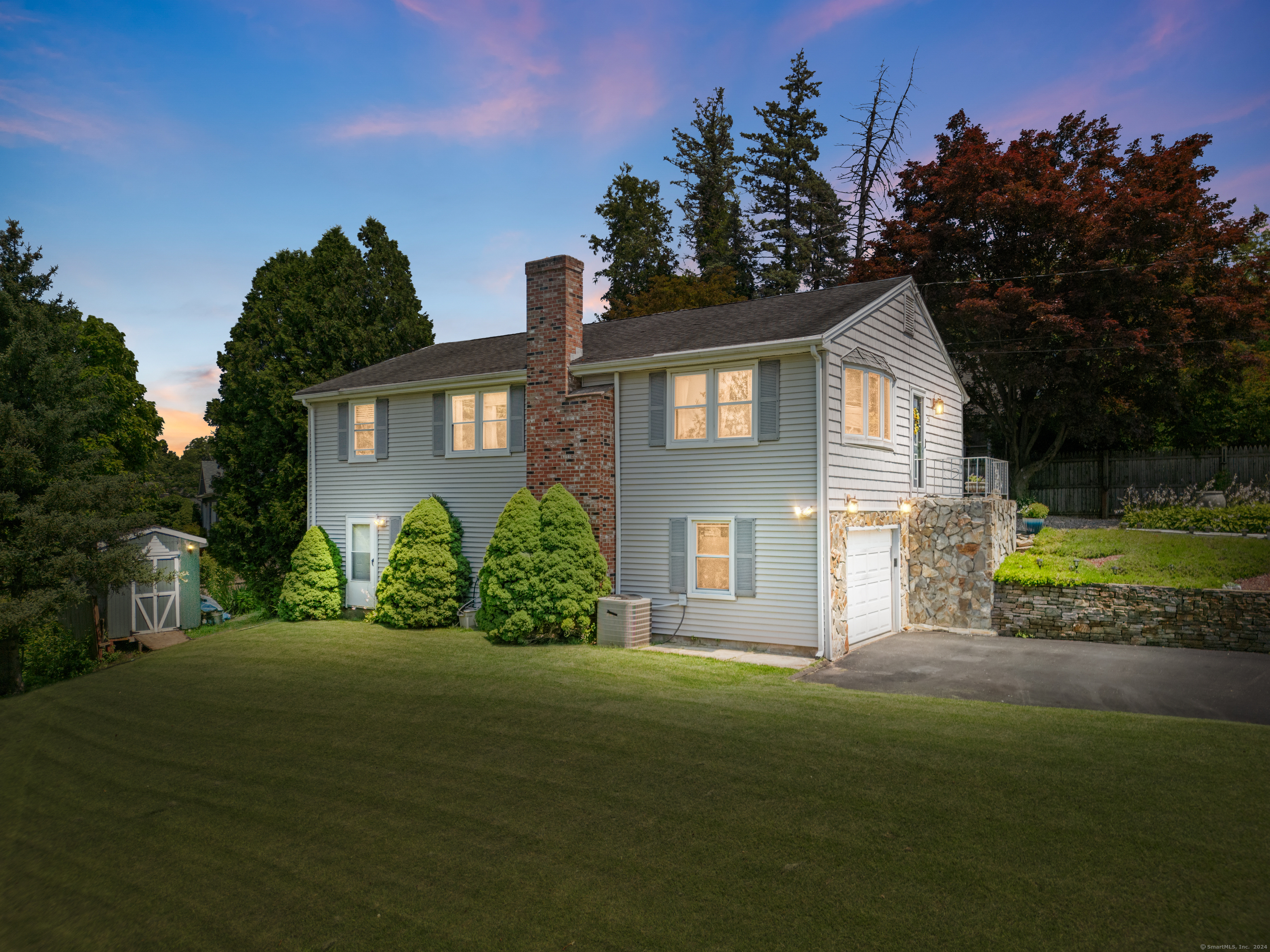 a front view of a house with a garden