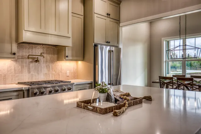 a kitchen with stainless steel appliances granite countertop a stove and a refrigerator