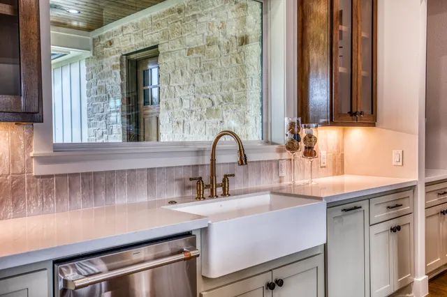 a kitchen with a sink and a window