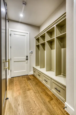 a view of an empty room with cabinet and a window