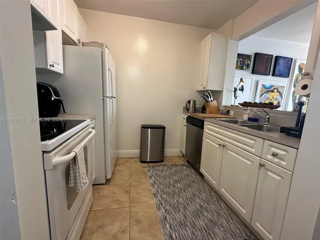 a kitchen with a sink stove and refrigerator