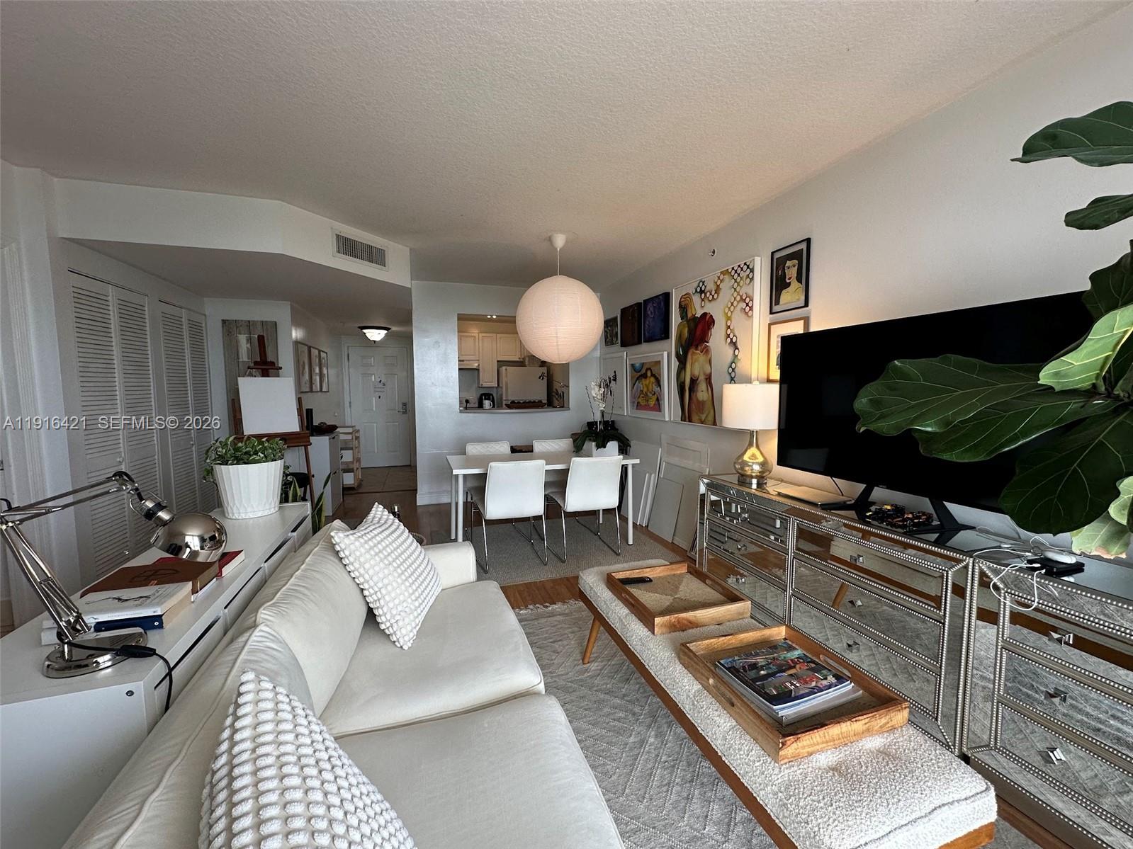 900 Southwest 8th Street, Unit 1010 Miami, FL 33130 - Photo 3 of 27 a living room with furniture and a flat screen tv