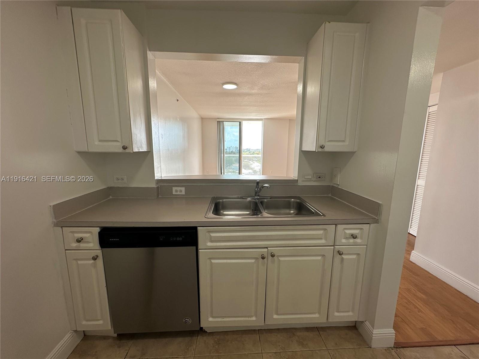 900 Southwest 8th Street, Unit 1010 Miami, FL 33130 - Photo 8 of 27 a kitchen with a sink stove and cabinets