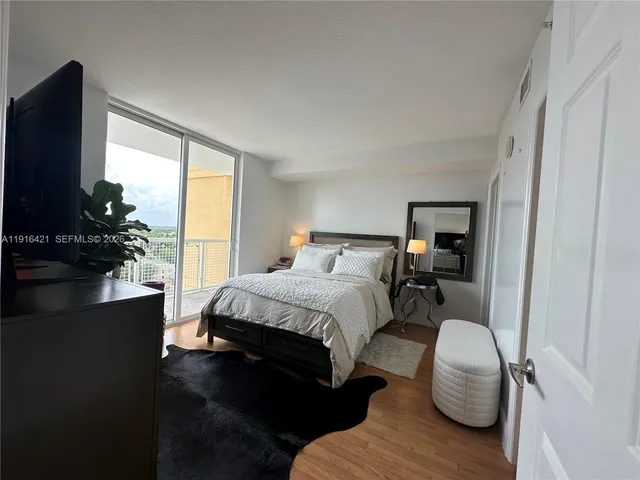 a bedroom with a bed and a large window