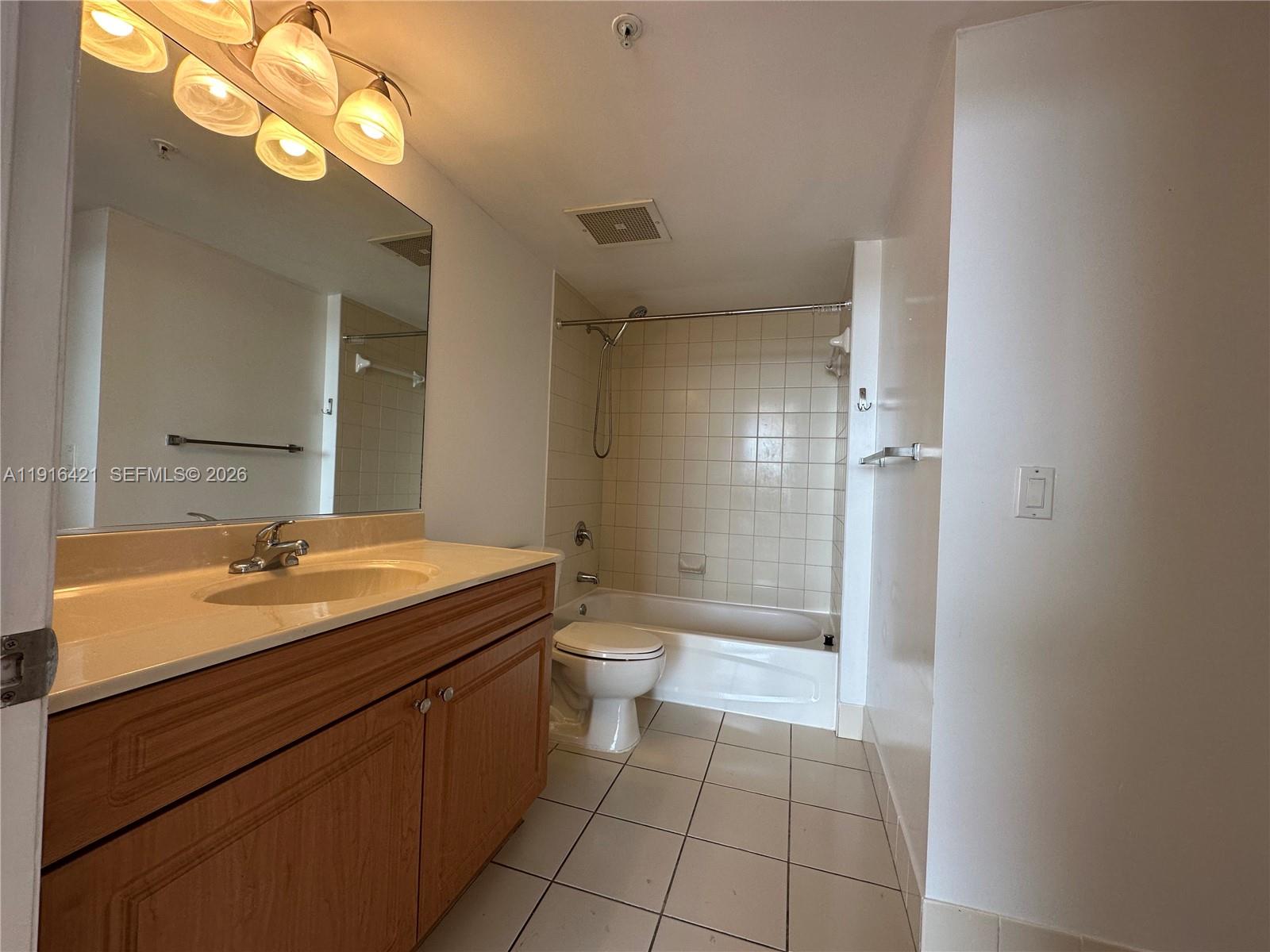 900 Southwest 8th Street, Unit 1010 Miami, FL 33130 - Photo 10 of 27 a bathroom with a granite countertop sink a toilet and a mirror