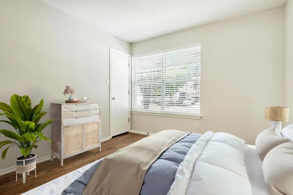 a bedroom with a bed and a window