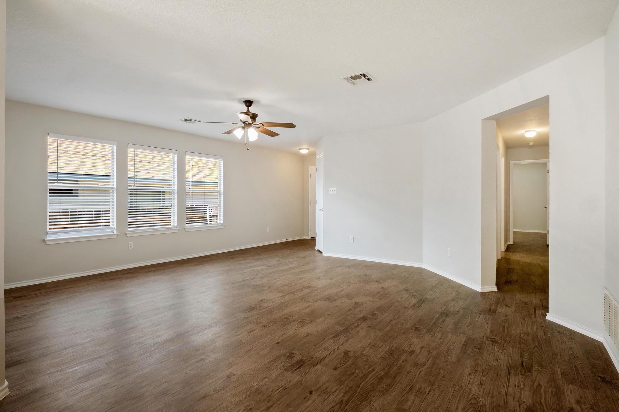 162 Brandons Way Buda, TX 78610 - Photo 22 of 36 wooden floor in an empty room with a window