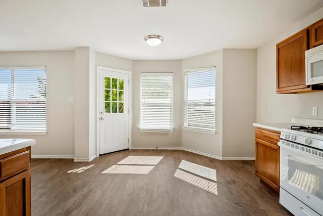 a view of a livingroom with wooden floor and a window