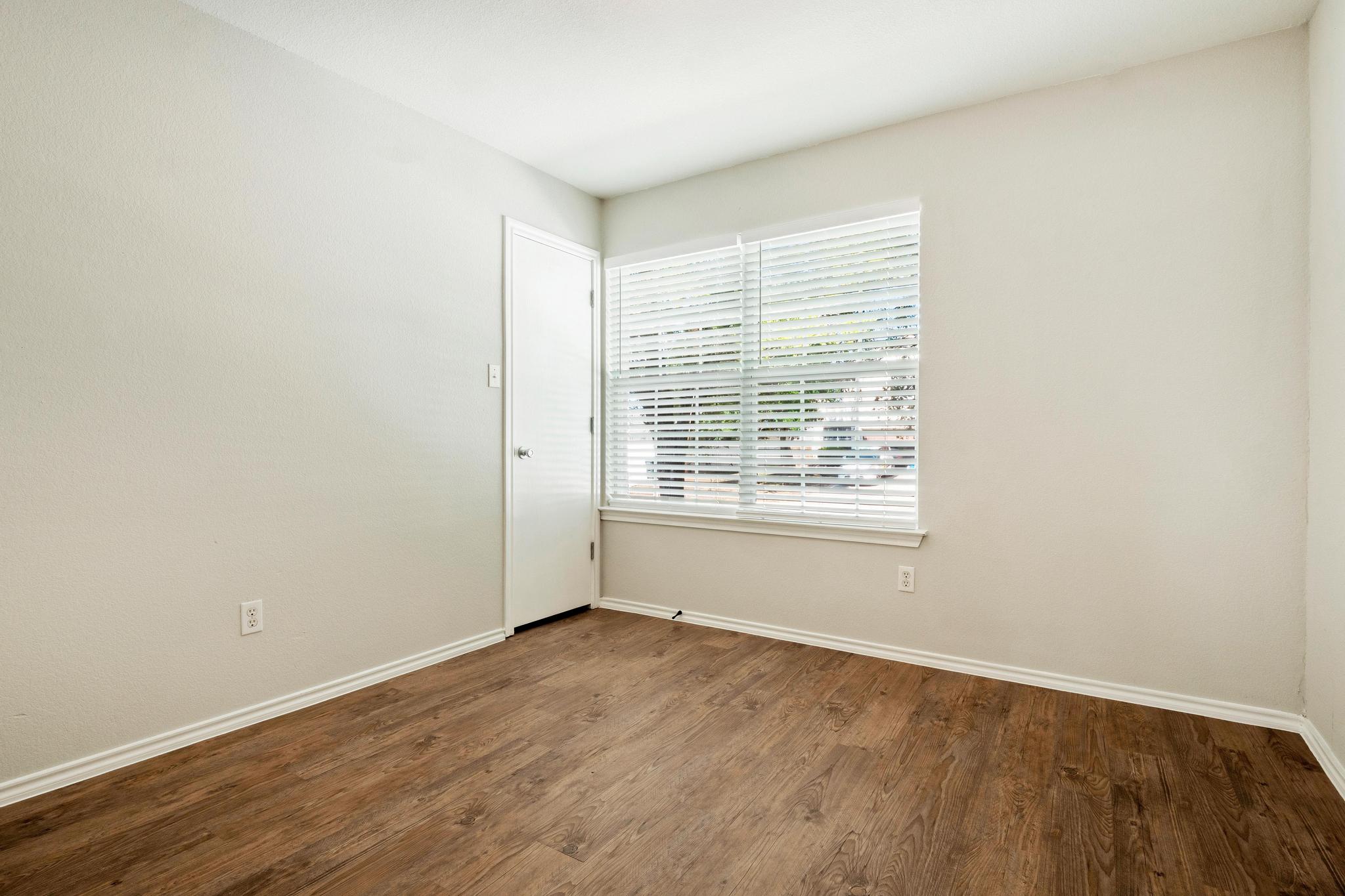162 Brandons Way Buda, TX 78610 - Photo 33 of 36 an empty room with wooden floor and windows