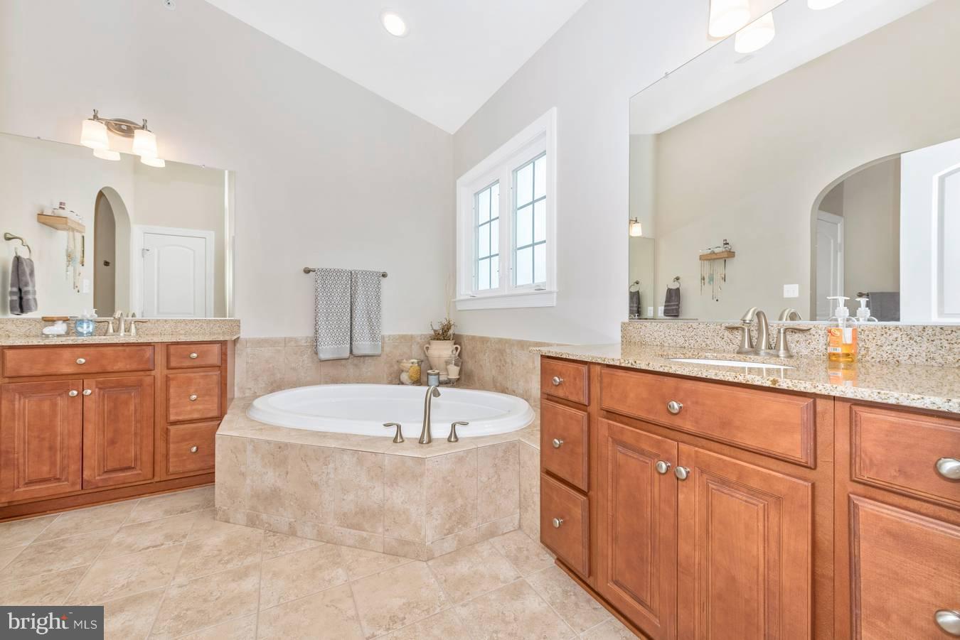 9158 Bealls Farm Road Frederick, MD 21704 - Photo 14 of 30 a spacious bathroom with a double vanity sink mirror and bathtub