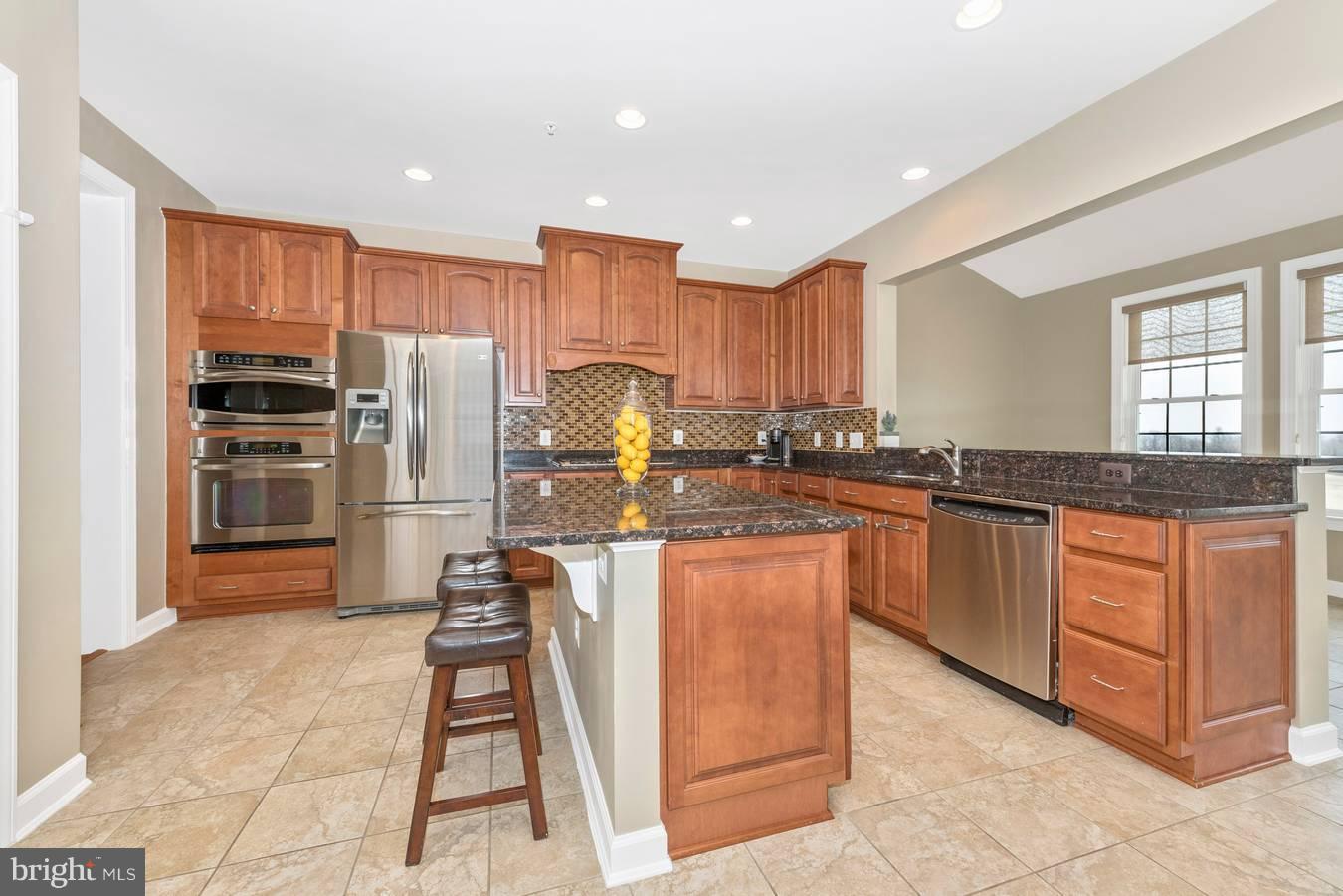 9158 Bealls Farm Road Frederick, MD 21704 - Photo 5 of 30 a kitchen with granite countertop a refrigerator stove top oven and sink