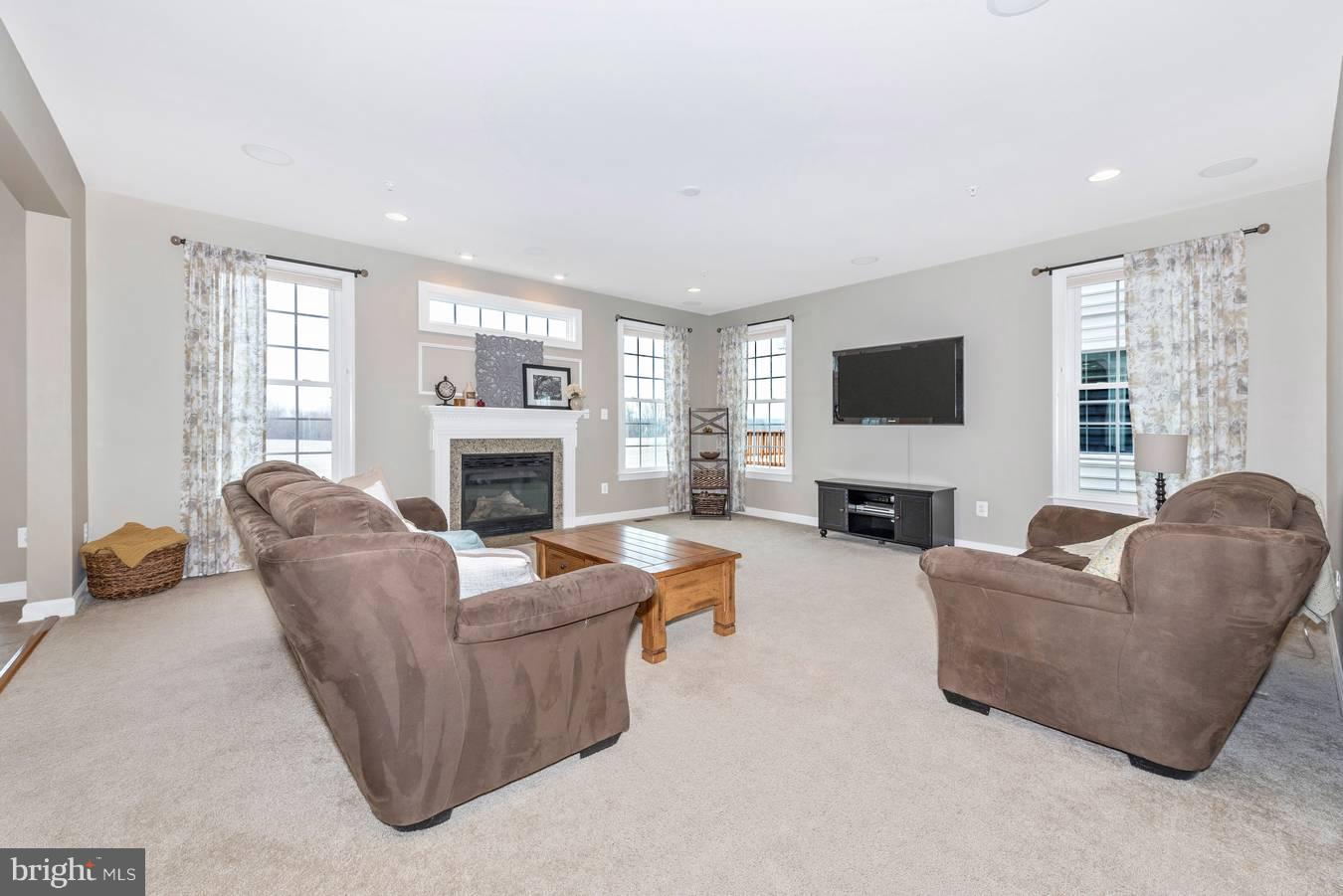 9158 Bealls Farm Road Frederick, MD 21704 - Photo 9 of 30 a living room with furniture flat screen tv and a fireplace