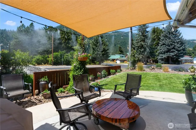 a view of a patio with table and chairs potted plants with wooden fence