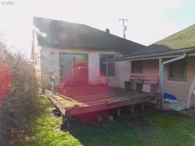 a backyard of a house with table and chairs